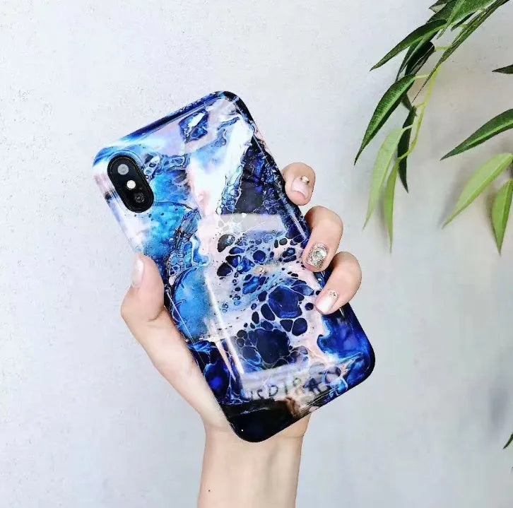 Colourful stone pattern soft back cover case for iPhone on a table.