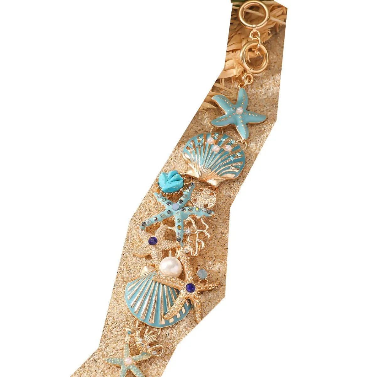 Alloy rhinestone bracelet with boat anchor and starfish design in turquoise, coral red, or coral blue.