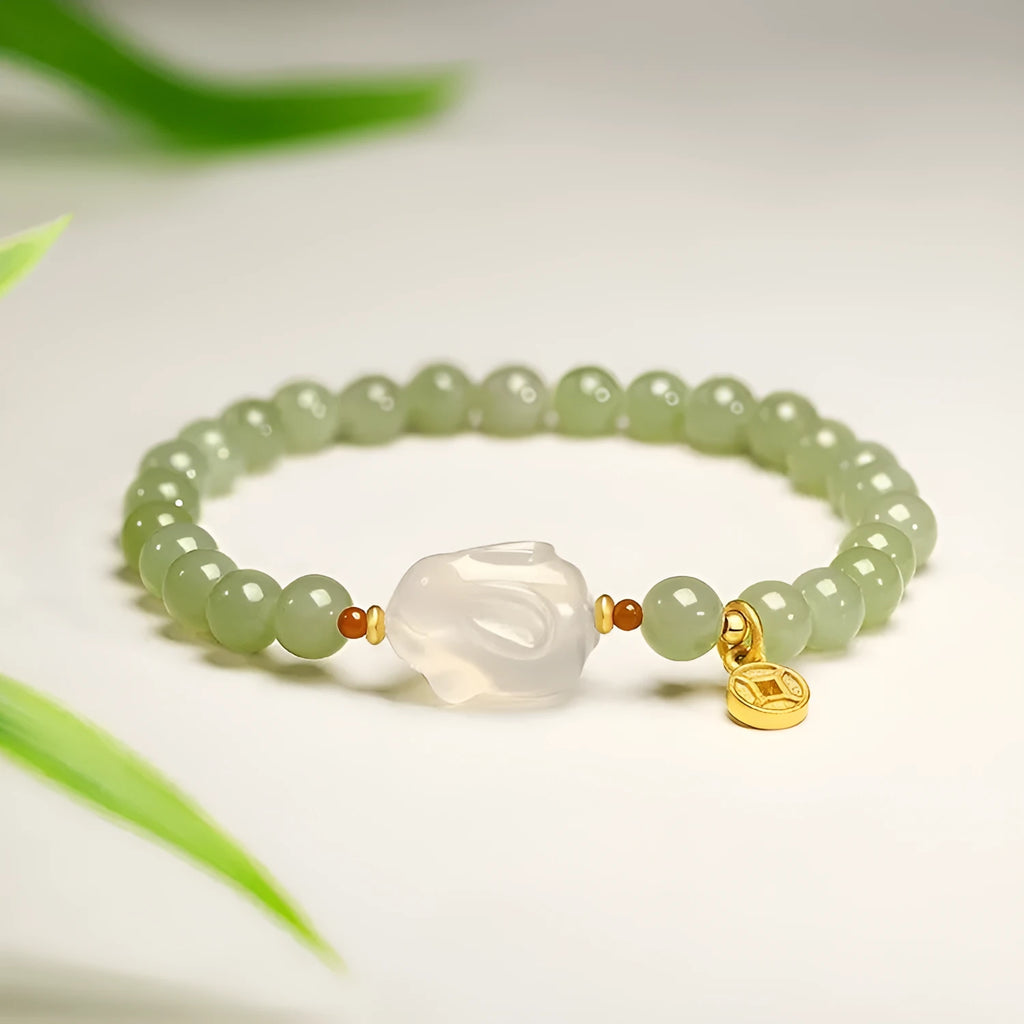 Handmade women's Hetian Jade Rabbit bracelet with glass rabbit charms in a gift box.