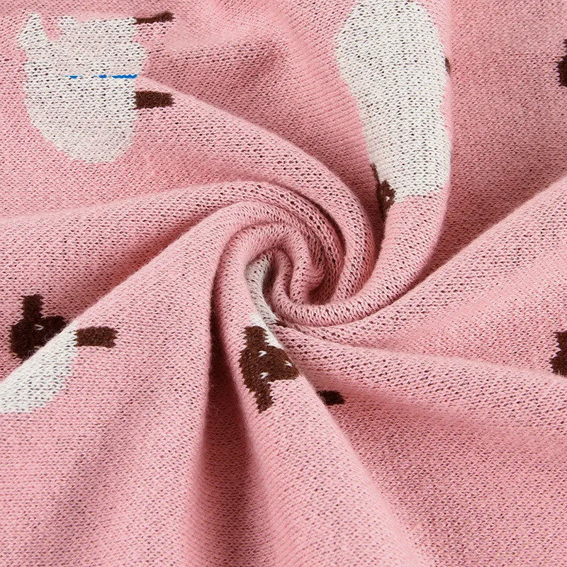 Soft pink baby blanket cover for a sheepskin, laid flat showing its rectangular 100cm by 80cm size.