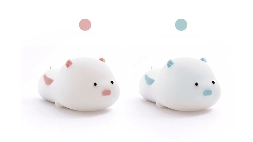Blue silicone pig-shaped night light with sleeping design and USB charging port