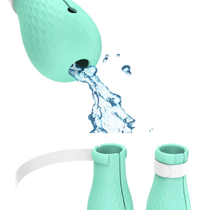 Green silicone cat bathing feet washing set with nylon buckle strap on a surface