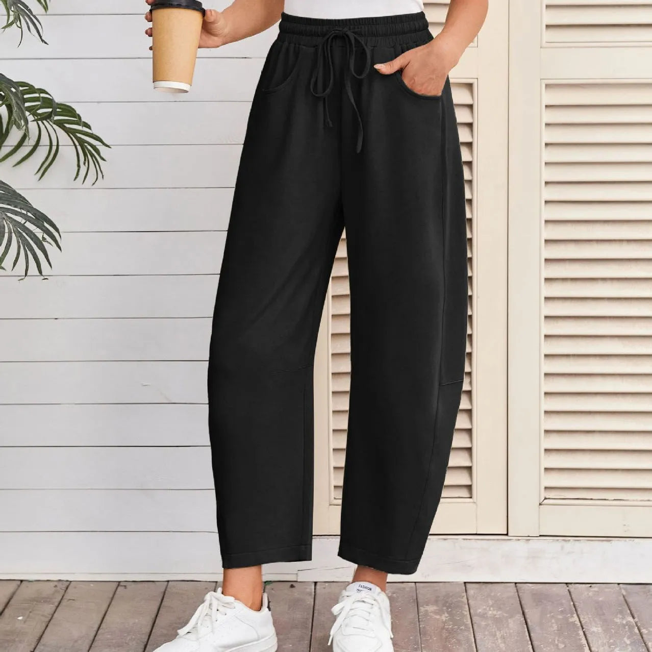 Loose cropped sweatpants with drawstring waist and side pockets in street fashion styling