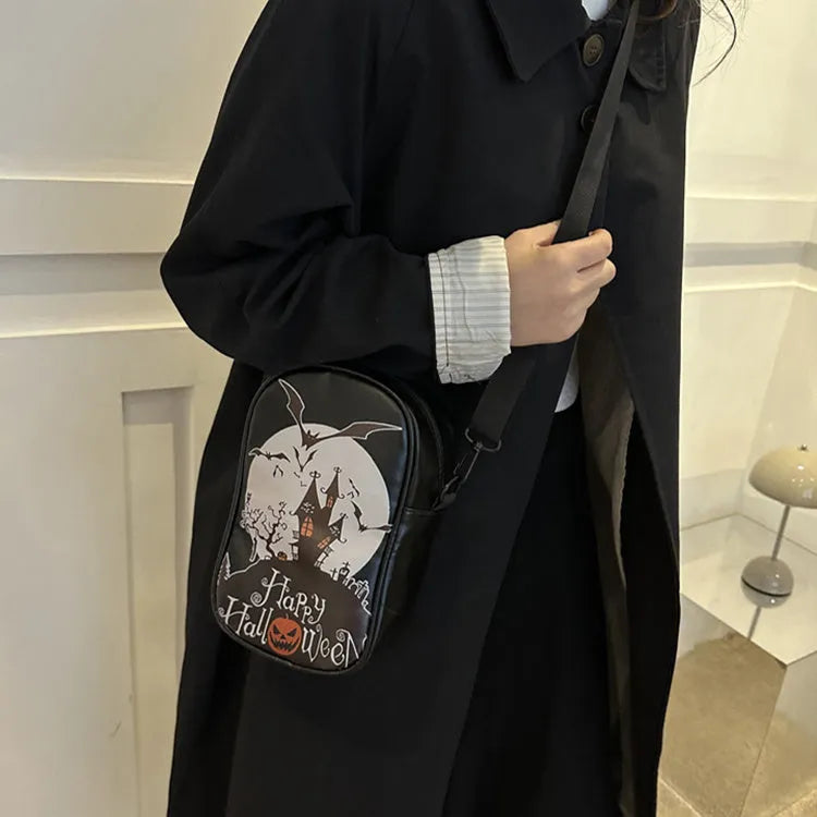 Halloween graffiti print crossbody phone bag with cartoon pumpkins, in multiple colours.