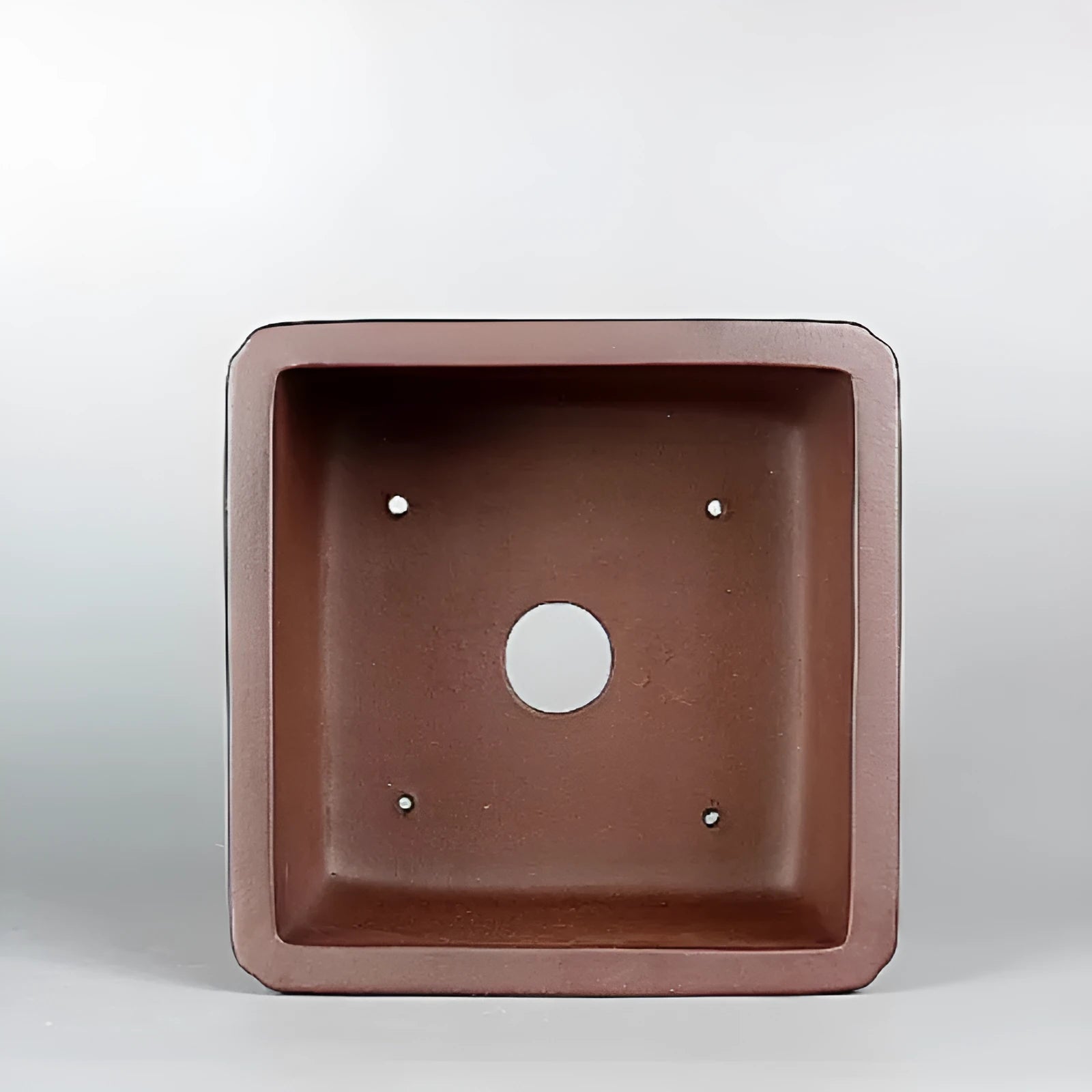 Brown handmade antique purple clay flower pot for indoor plants.