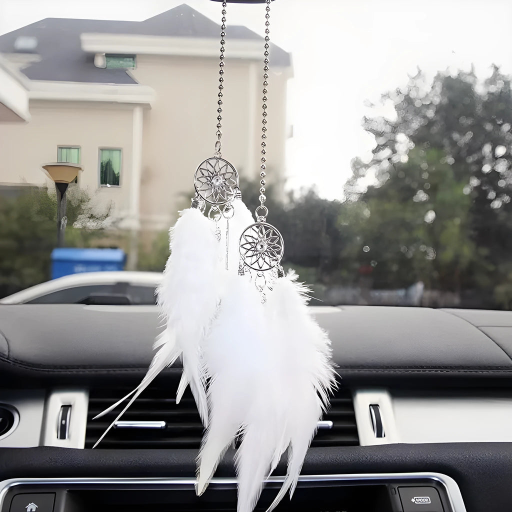 Dreamcatcher car ornament with metal frame and feather in one of six colours on car interior
