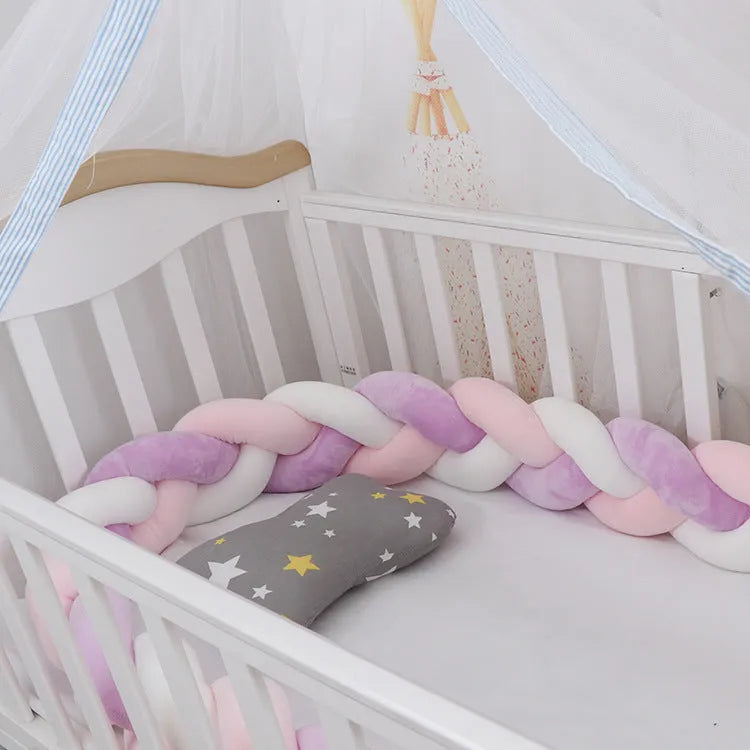 Baby cot bumper braid in spandex crystal velvet, shown in a light grey colour, wrapped around white crib rails.