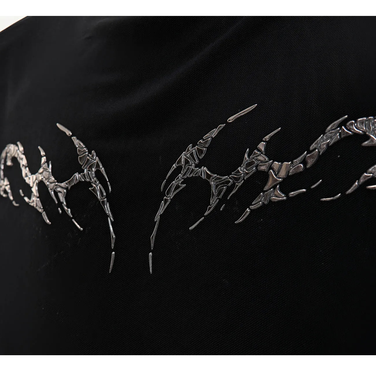 Slim-fit long-sleeved mesh shirt in black, shown as a base layer for athletic wear.