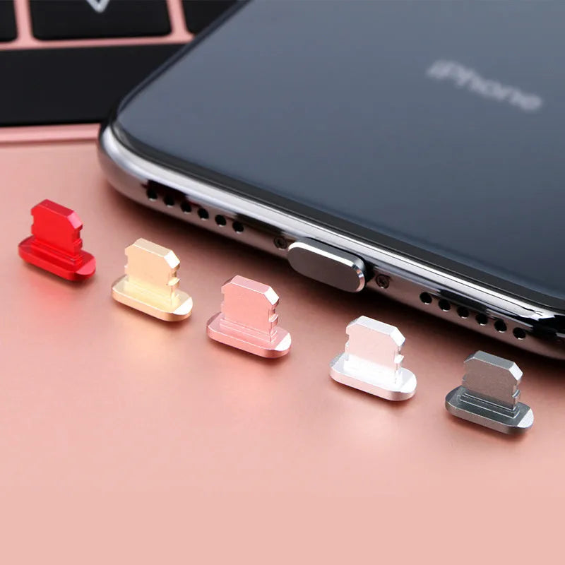 Aluminium alloy charging port dust plug for iPhone in various colours including gold, black, and rose gold.