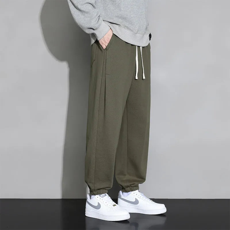 Men's loose fit sports trousers in grey colour with elastic waistband and drawstring closure