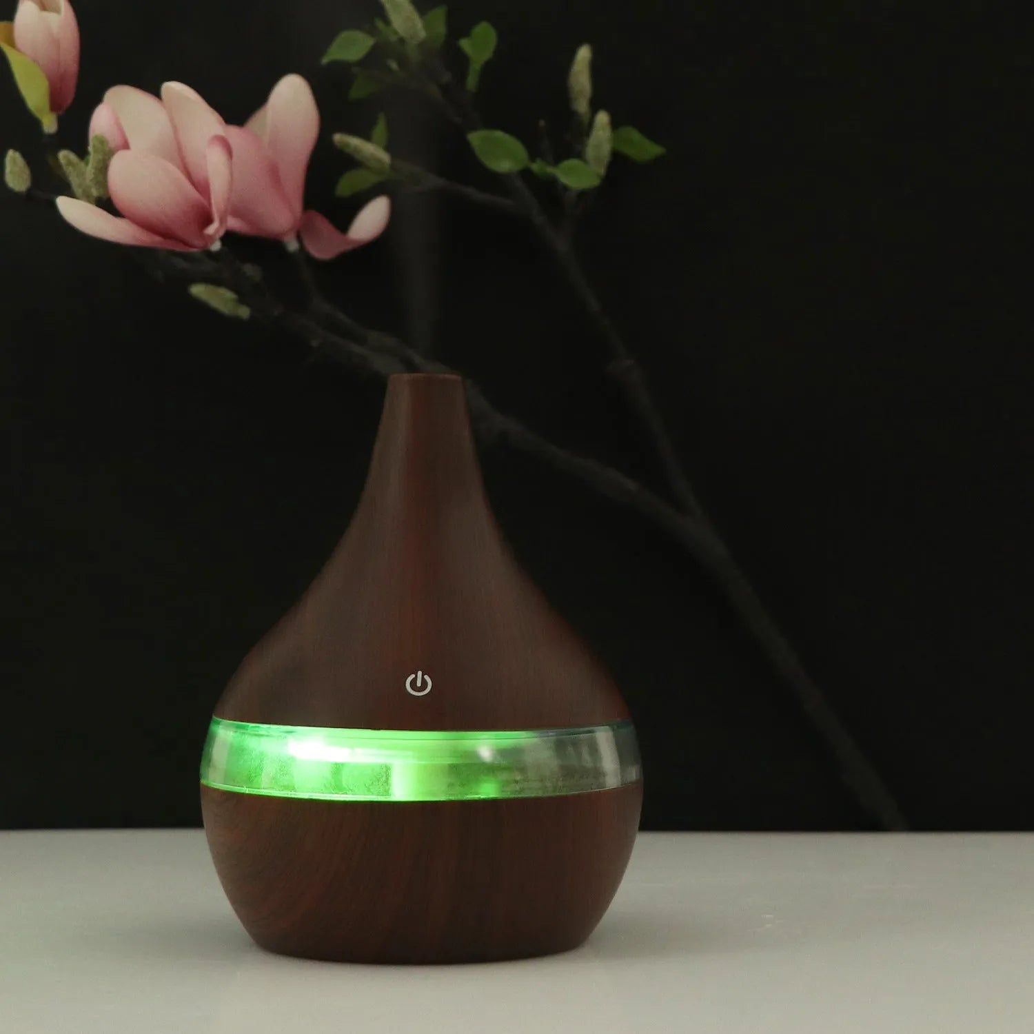 Columnar USB mini air purifier and humidifier in light wood grain finish on a desk.