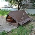 Brown A-line tent for 2-3 people with PU4000 waterproof fabric, 210x150x110cm, set in a grassy campsite.