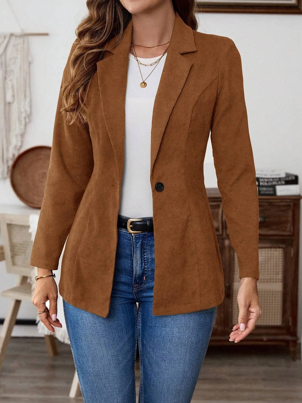 Brown single-breasted lapel leisure suit coat with long sleeves on a hanger