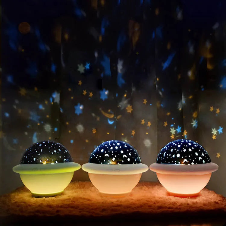 Green UFO-shaped star projection night light on wooden table showing star patterns on wall