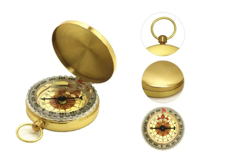 Gold metal flip compass with open lid showing compass face, pocket watch style