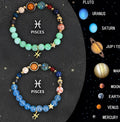Two natural stone beaded bracelets with zodiac sign charms on a wooden surface.