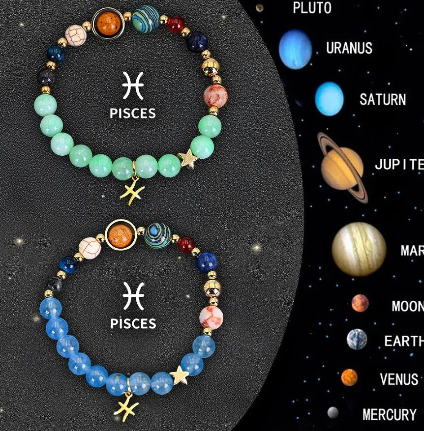 Two natural stone beaded bracelets with zodiac sign charms on a wooden surface.