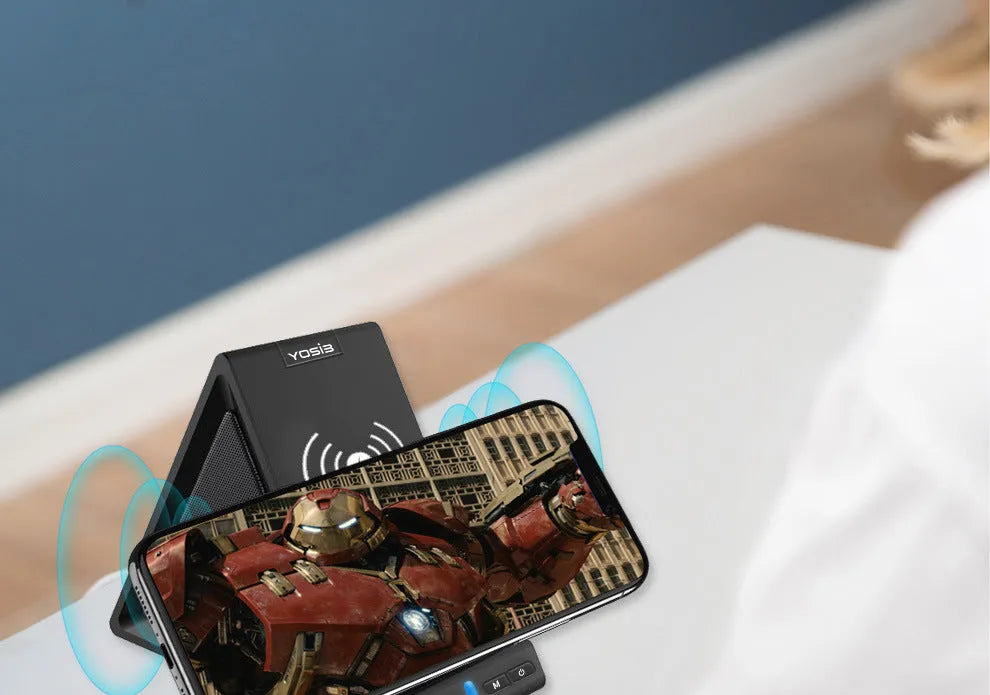 Black multifunctional Bluetooth speaker with phone stand and wireless charging ports.