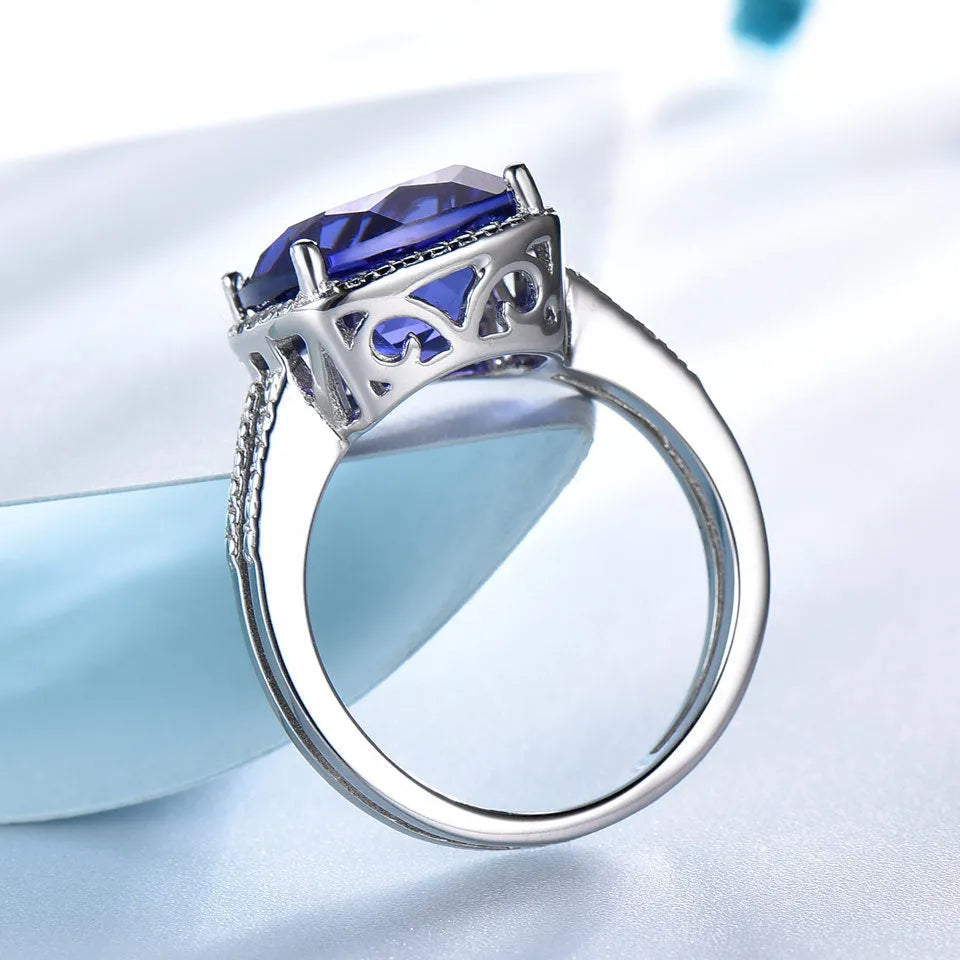 A blue tanzanite stone set in a sterling silver women's ring, showing front detail.