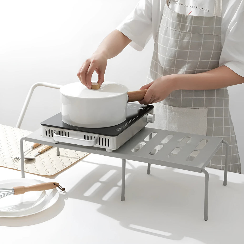 White telescopic kitchen rack with adjustable height showing extended and compressed positions