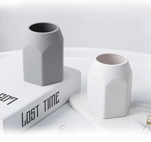 Round solid silicone pen holder in grey on a desk with pens inserted, 80x95mm