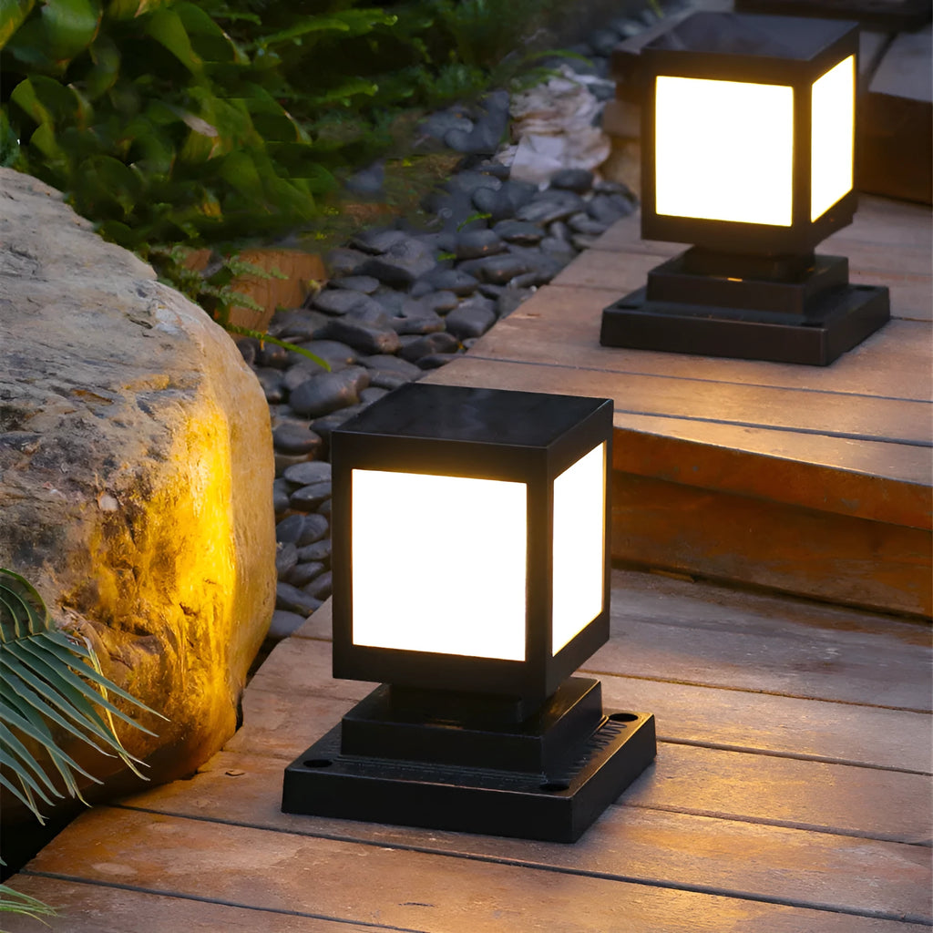 A set of waterproof solar-powered garden lights installed along a lawn edge and wall.