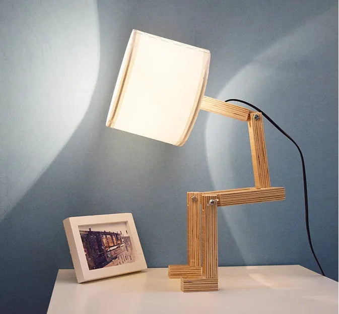 Creative wooden humanoid table lamp with white fabric shade, deformable design, 22x44x16cm