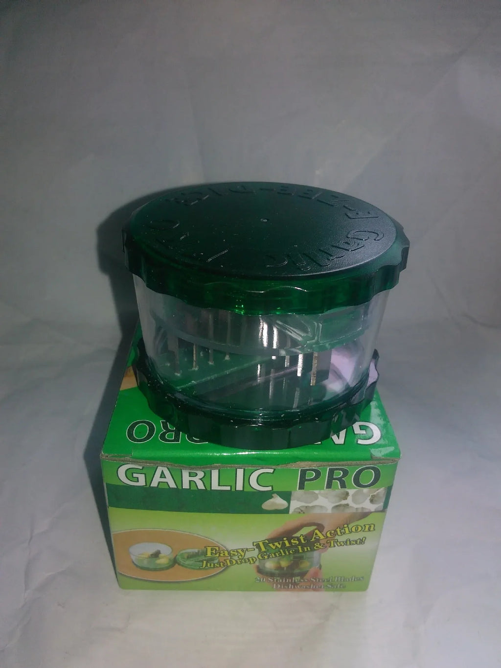 Green transparent polypropylene garlic peeler kitchen tool measuring 8.5 by 8.5 by 6 cm.