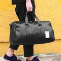 Black waterproof sports fitness bag with separate shoe compartments and diagonal carrying straps