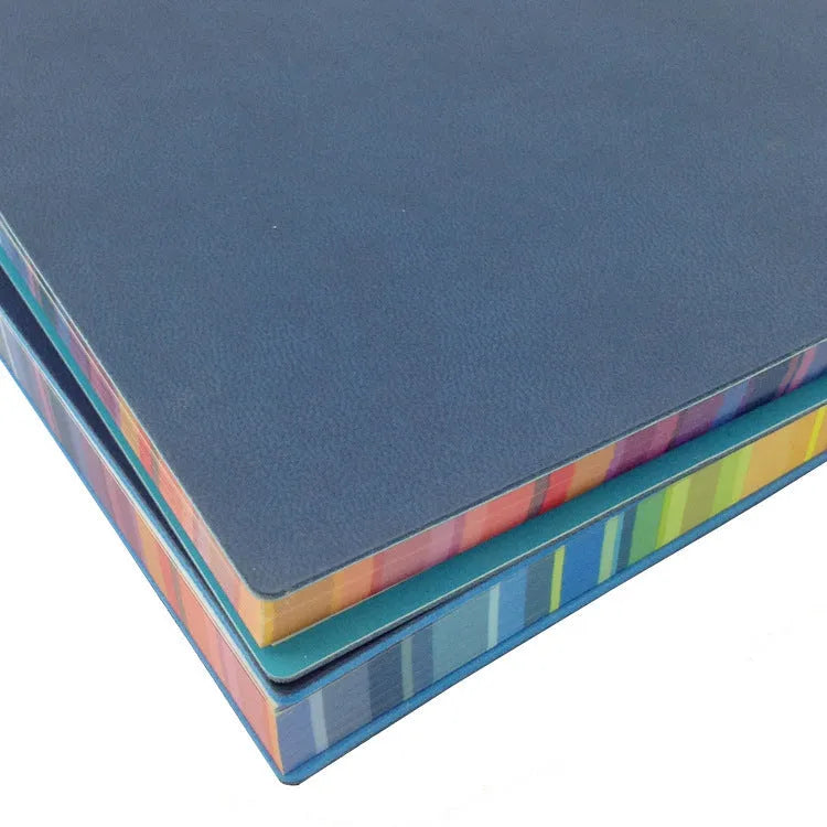 A5 rainbow side PU leather cover notebook open on a desk, showing lock line hardcover binding and 100g Daolin paper pages