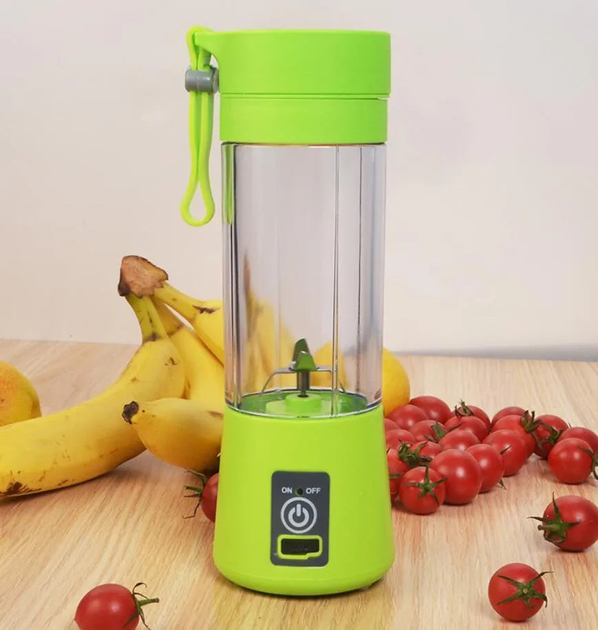 Pink mini USB electric fruit juicer with carrying rope on a kitchen countertop.