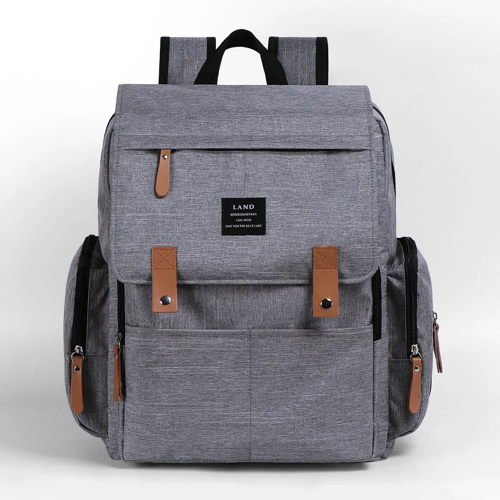 Land Mommy large oxford cloth diaper backpack in grey with a changing mat, shown open.