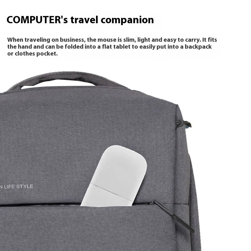 Black folding Bluetooth wireless mouse shown both folded and unfolded beside laptop