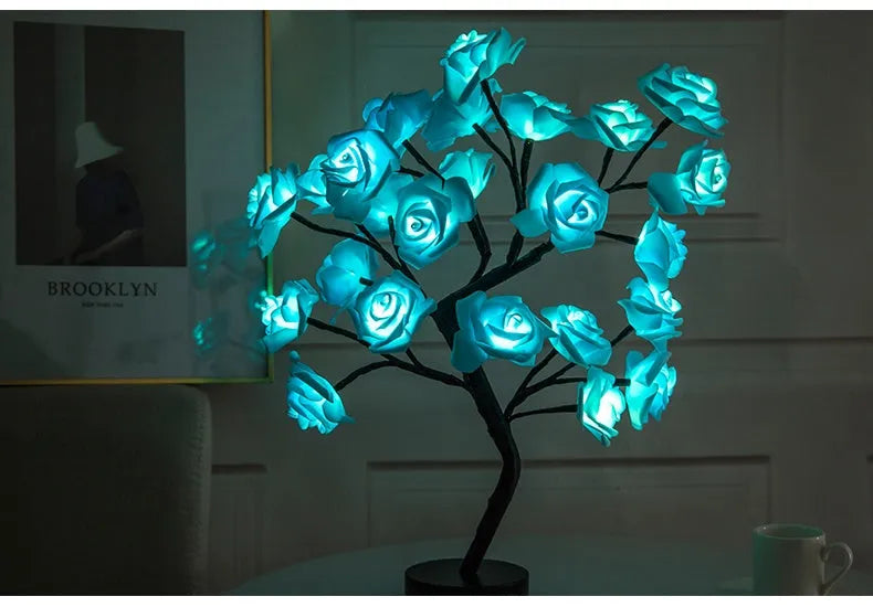 White and red rose flower LED table lamp with bonsai tree lights on a table.