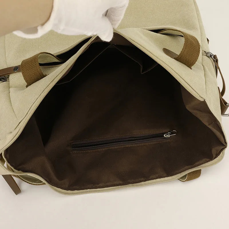 Large khaki retro canvas shoulder bag for women showing external sandwich pocket and internal organiser compartments.