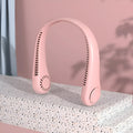 A pink bladeless neck fan hanging around a person's neck, showing its compact design and air outlets.