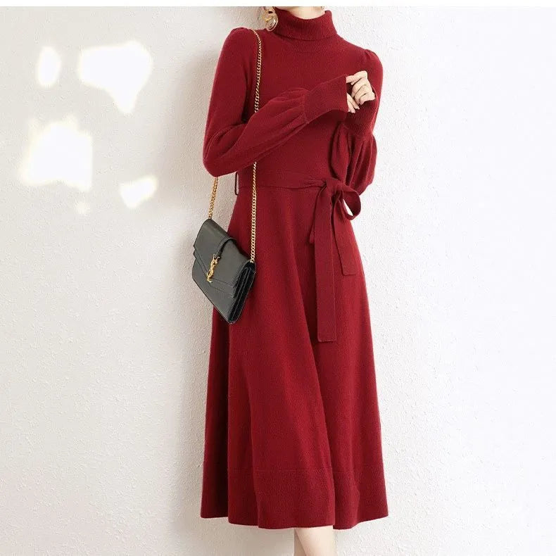 Rose red turtleneck knit dress with long sleeves, elastic waist, and loose mid-length sweater skirt hem.