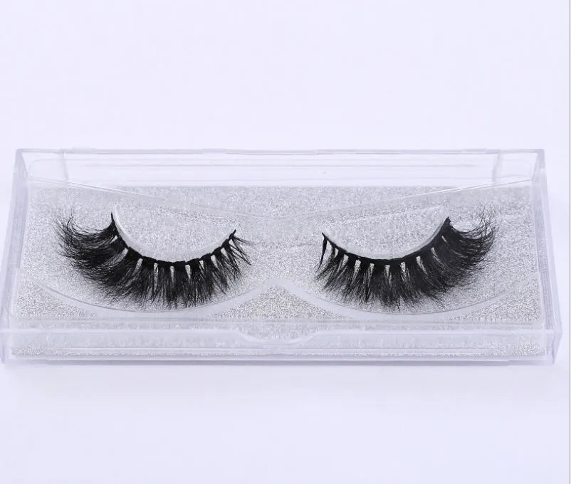 Pair of faux mink eyelashes with long tail and cotton stem against white background