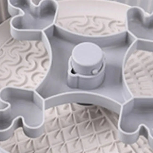 Slow feeder dog bowl with rotating game board and textured silicone licking mat insert.