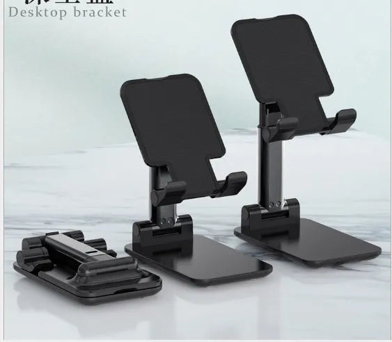 Black silicone and ABS plastic desk mobile phone holder on a wooden table.