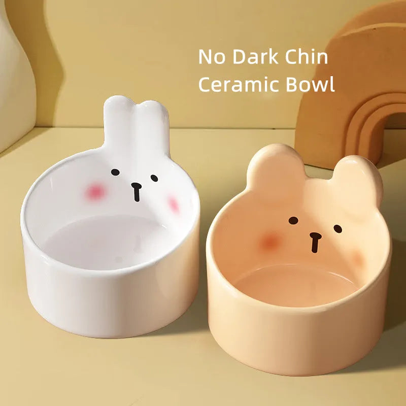 White and yellow ceramic pet bowls with raised neck guards in two sizes.