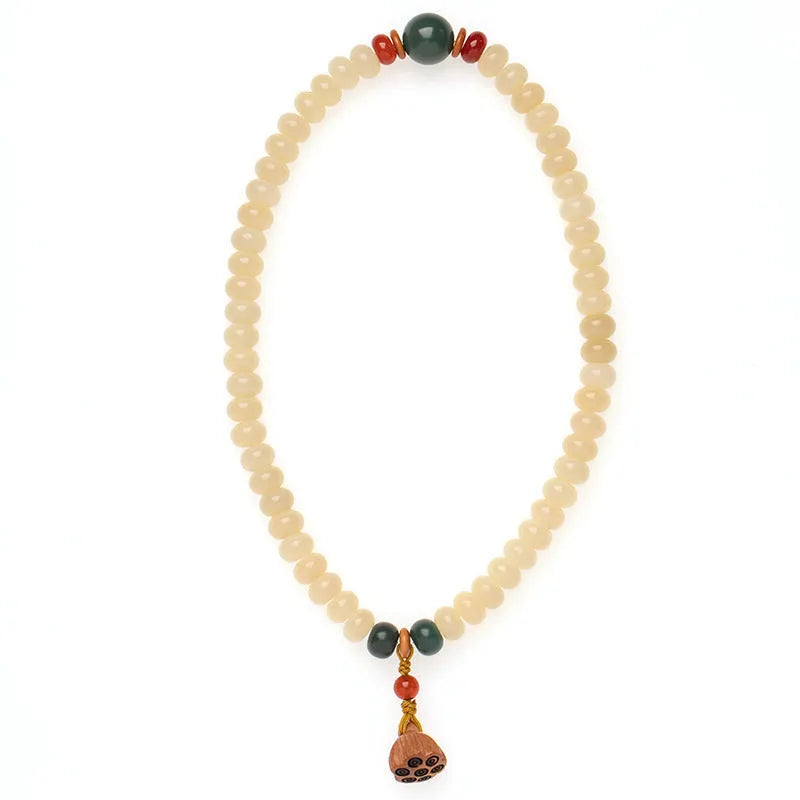 Milk butter coloured Bodhi root wood bracelet with 6x9mm flat round beads on wrist