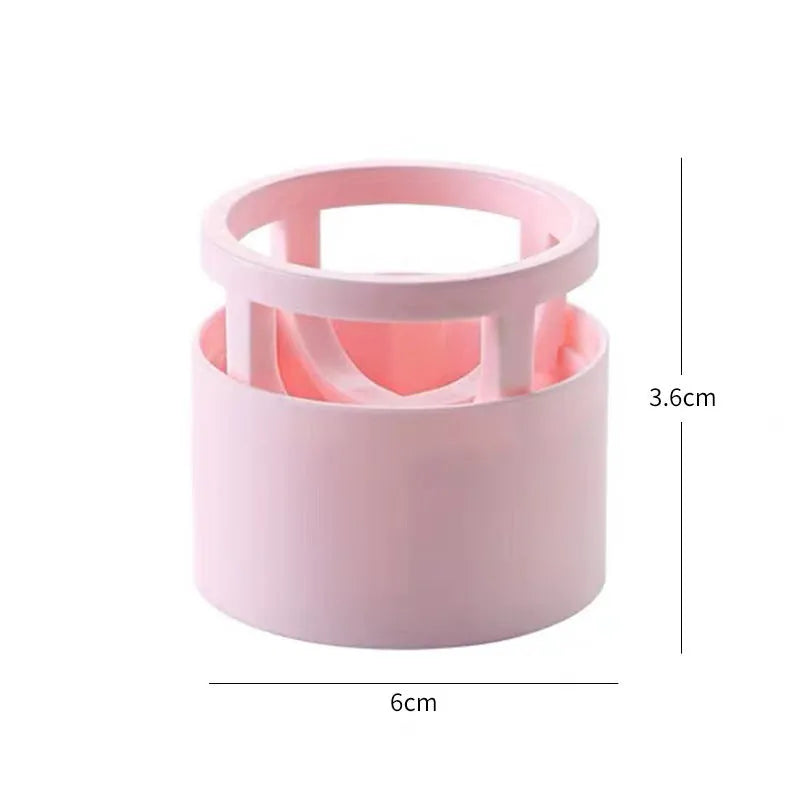 Pink plastic beauty egg stand in girly heart style for dustproof cosmetics storage on a bedroom surface