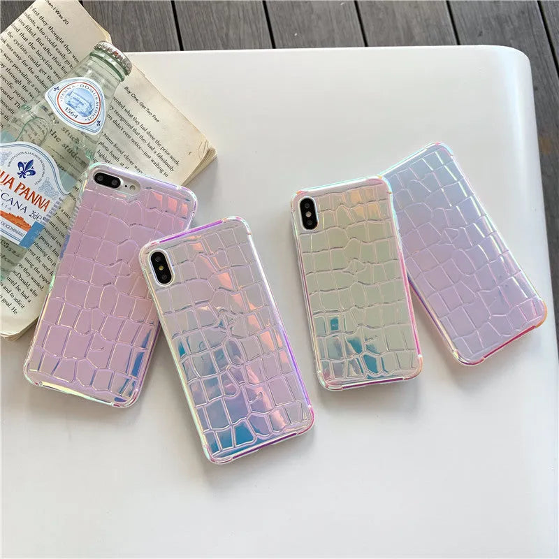 Glossy silver silicone phone case with a laser-etched irregular texture for iPhone, showing raised camera protection.