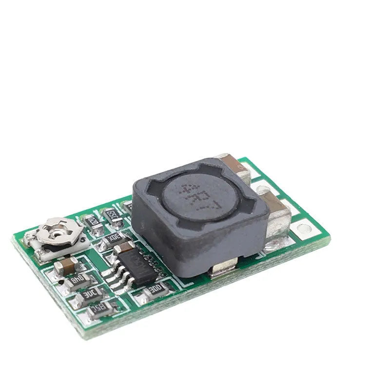 Green mini DC-DC step down power module converting 12-24V to 5V 3A output.