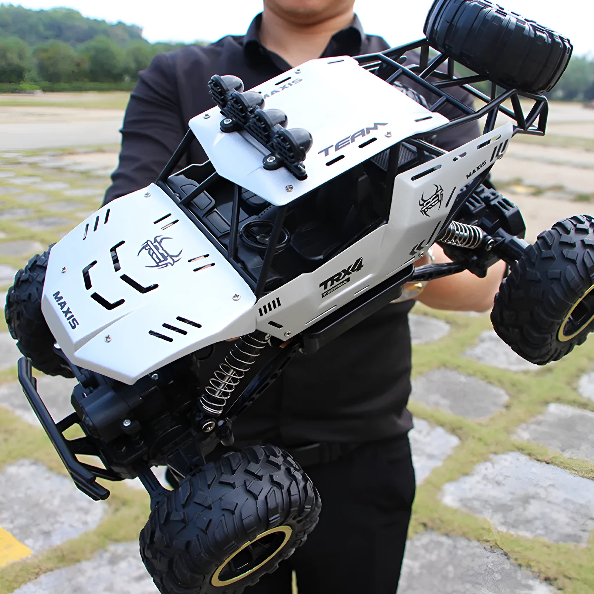 Large black 4WD remote control climbing car and smaller silver high-speed model with 2.4G remote.