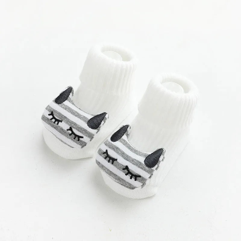Baby socks with non-slip rubber grip soles on the feet, shown in a light grey colour.