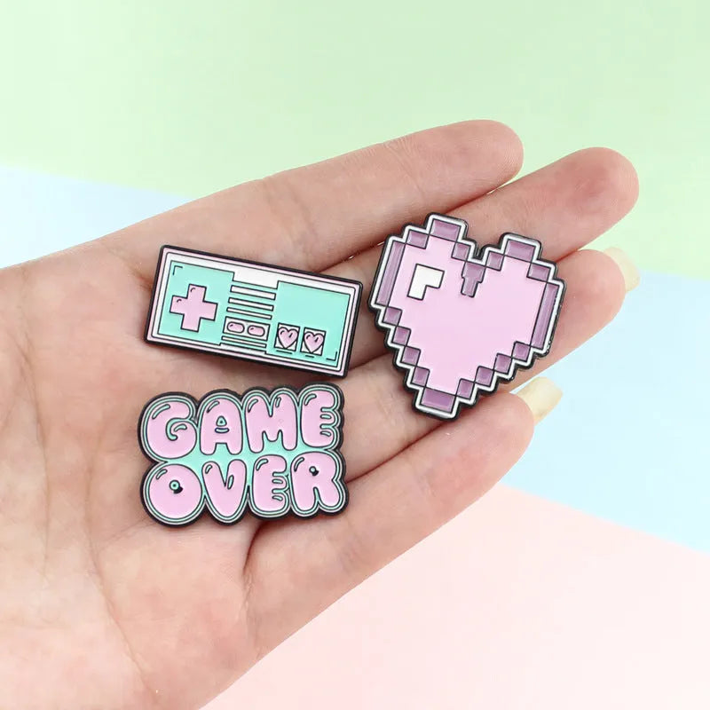 Stereo game console metal alloy badge with pin back, shown in available colours on a backpack strap