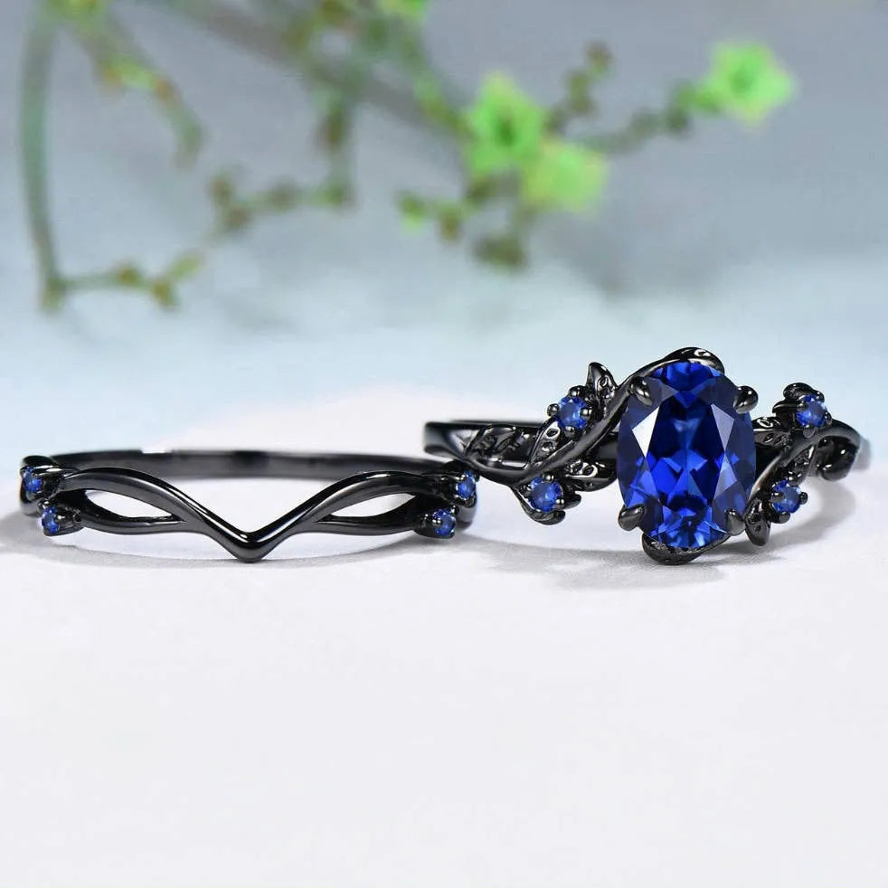 Geometric gun black women's couple ring with a navy blue rhinestone inlay on a copper band.