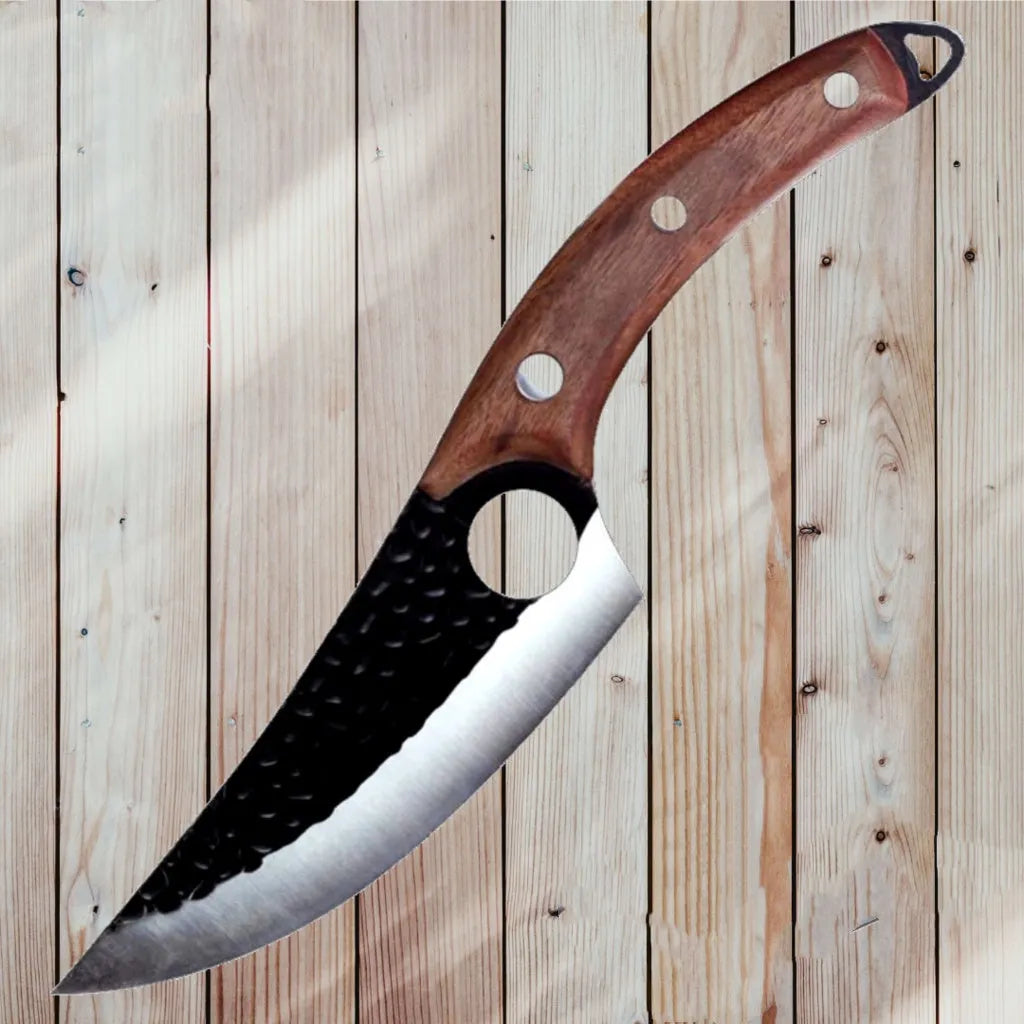Curved boning butcher knife with hammer-pattern blade and brown leather sheath on a cutting board.